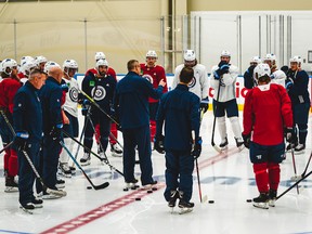 Winnipeg Jets coach Paul Maurice, centre, talks to his team at the Downtown Community Arena in Edmonton on Monday, July 27, 2019.
