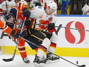 Edmonton Oilers forward Joakim Nygard (10) and Calgary Flames forward Michael Backlund (11) battle for a loose puck at Rogers Place on Jan. 29, 2020.