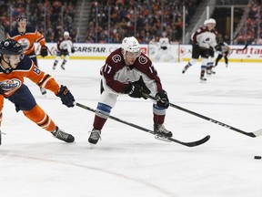 Edmonton Oilers' Matt Benning (83) reaches for Colorado Avalanche's Tyson Jost (17) at Rogers Place in this file photo taken Feb. 22, 2018.