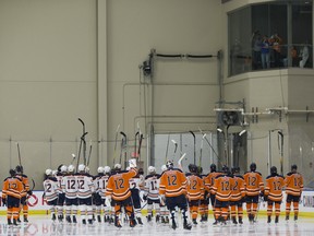 Members of the Edmonton Oiler raise their sticks to the family of  Colby Cave prior to a scrimmage to pay tribute to their fallen teammate and raise money for the Colby Cave Memorial Fund on Saturday, July 25, 2020.