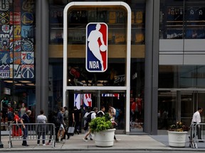 The NBA logo is displayed as people pass by the NBA Store in New York City, Oct. 7, 2019.