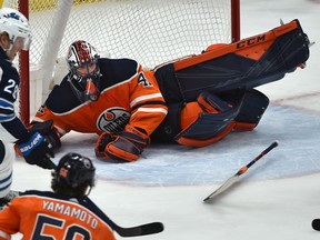 Edmonton Oilers goalie Mike Smith (41) dives across the cease and loses his stick after being caught out of position against the Winnipeg Jets at Rogers Place on March 11, 2020.