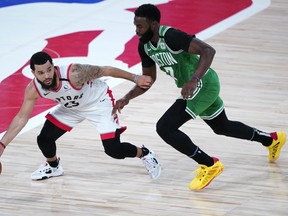 Raptors guard Fred VanVleet tries to get around Boston's Jaylen Brown during a regular-season game. Their playoff series, which could open on Saturday, is expected to be a slugfest with both teams evenly matched.