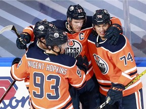 Connor McDavid #97 of the Edmonton Oilers celebrates with his teammates after scoring a goal against Corey Crawford #50 of the Chicago Blackhawks during the first period in Game 2 of the Western Conference Qualification Round at Rogers Place on August 03, 2020.