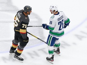 Antoine Roussel #26 of the Vancouver Canucks challenges Ryan Reaves #75 of the Vegas Golden Knights in Game 1 of the Western Conference second round of the 2020 NHL Stanley Cup Playoffs at Rogers Place on August 23, 2020.