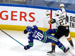Shea Theodore #27 of the Vegas Golden Knights checks Brandon Sutter #20 of the Vancouver Canucks during the second period in Game 4 of the Western Conference Second Round during the 2020 NHL Stanley Cup Playoffs at Rogers Place on August 30, 2020.