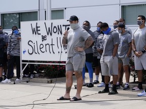 Detroit Lions' Taylor Decker addresses the media with his teammates outside the team's camp practice facility on Tuesday.