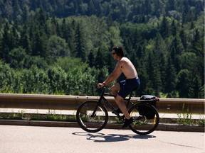 A cyclist rides up the Victoria Park Road hill on a hot day in Edmonton, on Wednesday, July 29, 2020.