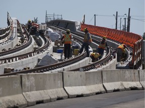 Construction workers prepare the Valley Line LRT along 83 Street near Argyll Road earlier in August.