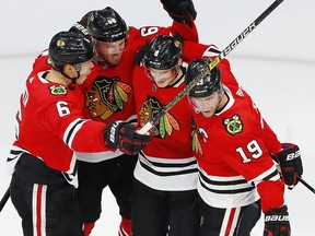 Chicago Blackhawks forward Jonathan Toews, (19) celebrates with Dominik Kubalik (8), Olli Maatta (6) and Slater Koekkoek (68) after going ahead 3-2 in the third period against the Edmonton Oilers during Game 4 of the Western Conference qualification series at Rogers Place on Friday, Aug. 7, 2020.