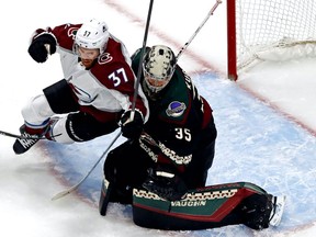 Colorado Avalanche left wing J.T. Compher (37) runs into Arizona Coyotes goaltender Darcy Kuemper (35) during the second period in Game 3 of the first round of the 2020 Stanley Cup Playoffs at Rogers Place on Aug. 15, 2020.