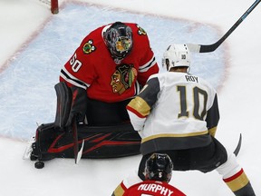 Chicago Blackhawks goaltender Corey Crawford (50) makes a save against Vegas Golden Knights center Nicolas Roy (10) during the first period in Game 4 of the first round of the 2020 Stanley Cup Playoffs at Rogers Place on Sunday Aug. 16, 2020. Mandatory Credit: