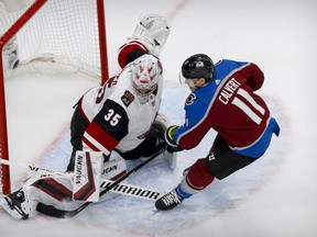 Colorado Avalanche left wing Matt Calvert (11) shoots the puck on net as Arizona Coyotes goaltender Darcy Kuemper (35) defends during the second period in Game 5 of the first round of the 2020 Stanley Cup Playoffs at Rogers Place on Aug. 19, 2020.