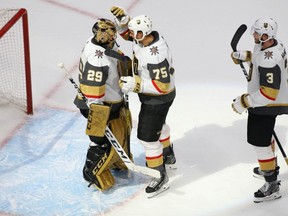 Vegas Golden Knights goaltender Marc-Andre Fleury (29) right wing Ryan Reaves (75) and defenseman Brayden McNabb (3) celebrate the 5-3 victory against the Vancouver Canucks  following Game 3 of the second round of the 2020 Stanley Cup Playoffs at Rogers Place on Aug. 30, 2020.
