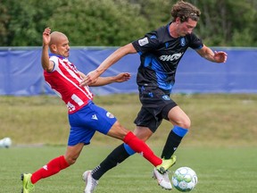 FC Edmonton striker Easton Ongaro, right, is challenge for the ball by Atletico Ottawa midfielder Javier Acuna at the Canadian Premier League Island Games tournament in Charlottetown, P.E.I., on Sunday Aug. 23, 2020.