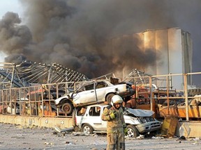 A picture shows the scene of an explosion at the port in Beirut on August 4, 2020. - Two huge explosion rocked the Lebanese capital Beirut, wounding dozens of people, shaking buildings and sending huge plumes of smoke billowing into the sky. Lebanese media carried images of people trapped under rubble, some bloodied, after the massive explosions, the cause of which was not immediately known.