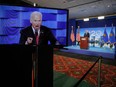 U.S. Democratic presidential candidate and former Vice President Joe Biden appears on a screen as Convention Co-Chair and Milwaukee Mayor Tom Barrett (back) opens the second night of the Democratic National Convention, being held virtually amid the novel coronavirus pandemic, at its hosting site in Milwaukee, Wisconsin, on Aug. 18, 2020.