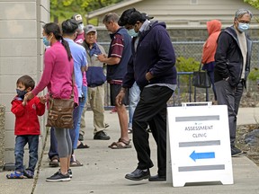 People lined up outside a COVID-19 drop-in testing centre in Edmonton on June 3, 2020 (Photo by Larry Wong/Postmedia)