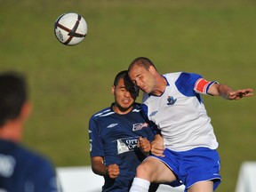 Kenny Caceros of the Ottawa Fury and Chris Kooy of FC Edmonton jump for a ball during an exhibition match in this file photo taken on July 6, 2010, at Foote Field.