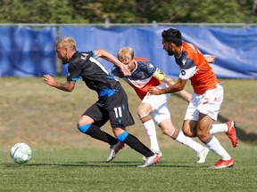 FC Edmonton striker Keven Aleman sprints away from a couple of Forge FC defenders at the Canadian Premier League Island Games tournament in Charlottetown, P.E.I., on Sunday Aug. 16, 2020.