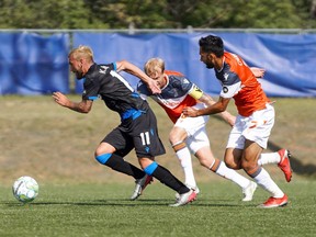 FC Edmonton striker Keven Aleman sprints away from a couple of Forge FC defenders at the Canadian Premier League Island Games tournament in Charlottetown, P.E.I., on Aug. 16, 2020.