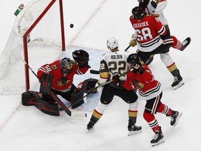Aug 16, 2020; Edmonton, Alberta, CAN; Chicago Blackhawks goaltender Corey Crawford (50) makes a save against Vegas Golden Knights defenseman Nick Holden (22) during the first period in game four of the first round of the 2020 Stanley Cup Playoffs at Rogers Place. Mandatory Credit: Perry Nelson-USA TODAY Sports ORG XMIT: USATSI-429699