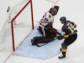 Aug 11, 2020; Edmonton, Alberta, CAN; Vegas Golden Knights right wing Reilly Smith (19) scores a goal past Chicago Blackhawks goaltender Corey Crawford (50) during the third period in game one of the first round of the 2020 Stanley Cup Playoffs at Rogers Place. Mandatory Credit: Perry Nelson-USA TODAY Sports ORG XMIT: USATSI-429679