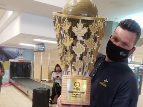 Edmonton Stingers president Brett Fraser arrives at the Edmonton International Airport on Monday, August 10 with the Canadian Elite Basketball League championship trophy in hand after the club won the Summer Series in St. Catharines, Ont. (Supplied/Edmonton Stingers)