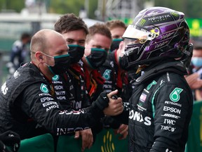 Mercedes' Lewis Hamilton celebrates with his team after winning the race Pool.