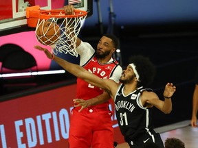 Raptors guard Norman Powell dunks against Jarrett Allen of the Nets during the second half in Game 4 of the first round of the NBA playoffs at The Field House at ESPN Wide World Of Sports Complex in Lake Buena Vista, Fla., Sunday, Aug. 23, 2020.