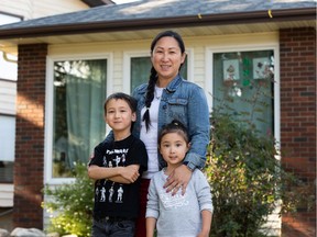 Linda Moon and her kids Eli Rawson, 6, and Melody Rawson, 3, are seen outside of their home in Edmonton, on Wednesday, Aug. 12, 2020. The family has decided that Eli will do online learning from home in the fall. Photo by Ian Kucerak/Postmedia