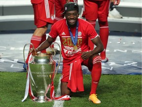 Bayern Munich's Alphonso Davies poses as he celebrates winning the Champions League with the trophy, Aug. 23, 2020.