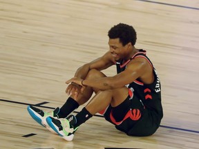 Toronto Raptors guard Kyle Lowry (7) sits on the court after Thursday's last-second win over Boston.