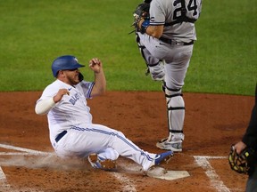 Alejandro Kirk of the Toronto Blue Jays slides safely to home plate during the third inning against the New York Yankees at Sahlen Field on September 21, 2020 in Buffalo, New York.