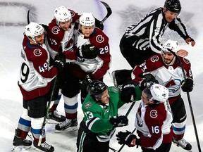 Nathan MacKinnon #29 of the Colorado Avalanche is congratulated by teammates after scoring an empty-net goal, while Mattias Janmark of the Dallas Stars scuffles with Nikita Zadorov in Game 6 of the Western Conference second round of the 2020 NHL Stanley Cup Playoffs at Rogers Place on Wednesday, Sept. 02, 2020.