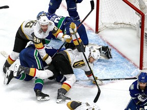 Alexander Edler 
(23) of the Vancouver Canucks gets tangled up with Paul Stastny (26) and William Karlsson (71) of the Vegas Golden Knights in Game Six of the Western Conference second round of the 2020 NHL Stanley Cup Playoffs at Rogers Place on Thursday, Sept. 03, 2020.