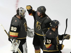 Robin Lehner (90) of the Vegas Golden Knights celebrates with teammates Zach Whitecloud (2) and Nicolas Roy (10) after defeating the Dallas Stars in Game 2 of the Western Conference final during the 2020 NHL Stanley Cup Playoffs at Rogers Place on Sept. 08, 2020.