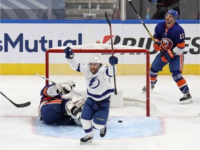 Brayden Point #21 of the Tampa Bay Lightning celebrates after scoring a goal past Semyon Varlamov #40 of the New York Islanders as Mathew Barzal #13 reacts during the third period in Game Four of the Eastern Conference Final during the 2020 NHL Stanley Cup Playoffs at Rogers Place, Sept. 13, 2020 in Edmonton.
