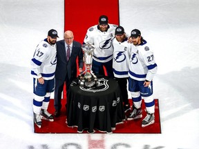 Bill Daly, the deputy commissioner and chief legal officer of the National Hockey League (NHL) presents the Prince of Wales Trophy to captains Alex Killorn #17, Victor Hedman #77, Steven Stamkos #91 and Ryan McDonagh #27 of the Tampa Bay Lightning after winning the Eastern Conference Championship over the New York Islanders in Game Six during the 2020 NHL Stanley Cup Playoffs at Rogers Place on September 17, 2020.