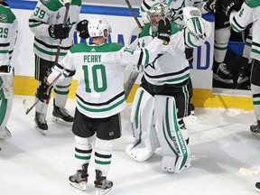 Corey Perry (10) and Anton Khudobin (35) of the Dallas Stars celebrate their victory over the Tampa Bay Lightning in the second overtime period of Game 5 of the 2020 NHL Stanley Cup Final at Rogers Place on Sept. 26, 2020.