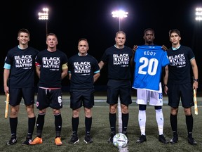 FC Edmonton captain Tomi Ameobi holds a jersey displaying former team captain Chris Kooy's No. 20 alongside officials and the opposing captain ahead of their opening match of the 2020 Canadian Premier League's Island Games against Forge FC in Charlottetown, P.E.I., on Aug. 16, 2020.