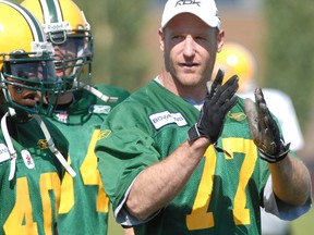 Former Edmonton Football Club linebacker A.J. Gass chats with some teammates at Clarke Park in this file photo from Aug. 12, 2006.