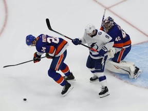 New York Islanders defenseman Scott Mayfield (24) helps goaltender Semyon Varlamov (40) defend the goal against Tampa Bay Lightning center Tyler Johnson (9) during the second period in Game 3 of the Eastern Conference Final of the 2020 Stanley Cup Playoffs at Rogers Place on Sept. 11, 2020.