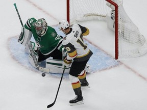 Dallas Stars goaltender Anton Khudobin (35) defends the goal against Vegas Golden Knights right wing Reilly Smith (19) during the third period in Game. 4 of the Western Conference Final of the 2020 Stanley Cup Playoffs at Rogers Place on Aug. 12, 2020.