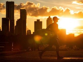 A runner exercises at sunset through Forest Heights Park in Edmonton, on Tuesday, Sept. 15, 2020.