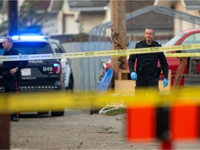 An Edmonton Police Service officer is seen as ASIRT investigates an officer-involved shooting near 68 Street and 118 Avenue on Friday, Sept. 18, 2020.
