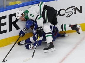 Tampa Bay Lightning right wing Nikita Kucherov (86) is checked by Dallas Stars defenseman Jamie Oleksiak (2) during the third period in game one of the 2020 Stanley Cup Final at Rogers Place on Sept. 19, 2020.