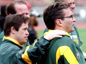Edmonton Football Club locker-room attendant Joey Moss puts his hand on the shoulder of equipment manager Dwayne Mandrusiak during 2010 training camp at Commonwealth Stadium in this file photo.