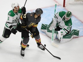 Dallas Stars goalie Jake Oettinger (29) plays a shot while Vegas Golden Knights left wing Max Pacioretty (67) and Dallas Stars defenceman Andrej Sekera (5) battle for position during Game 2 of the Western Conference final of the 2020 Stanley Cup Playoffs at Rogers Place.