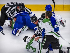 Officials break up fights between the Dallas Stars and Tampa Bay Lightning in Game 2 of the 2020 Stanley Cup Finals on Monday, Sept. 21, 2020, at Rogers Place.